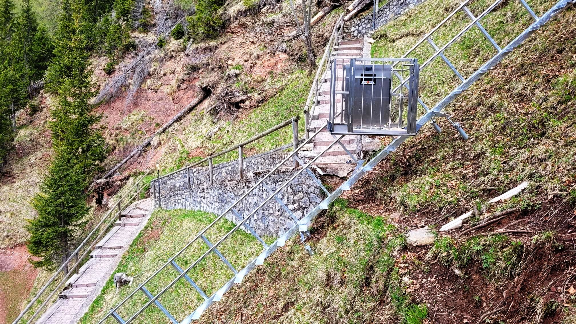 Modern stainless steel platform lift installed in a bright contemporary architectural space